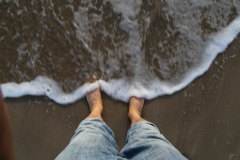 Mit nackten Füßen im Meer